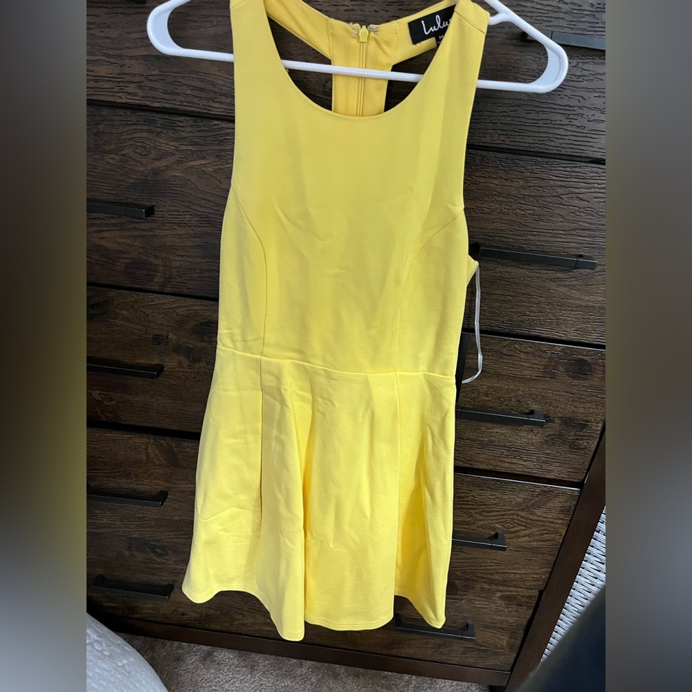 Yellow high neck skater dress with cut outs on the back